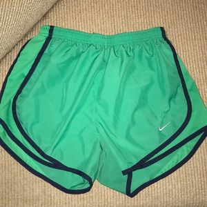 Green Nike shorts with navy trim